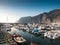 Toned image of lots of motorboats, ships and yachts moored in the port at Los Gigantes, Tenerife island