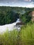 Toned image of majestic waterfall in the park Murchison Falls in Uganda against the background of the jungle