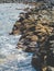 Toned image of ocean rocky coast. Sharp clifs and calm ocean surface on bright sunny day