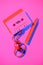 toned pink picture of retro audio cassette with pencil