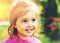 Toned portrait of Cute little girl smiling in sunny summer day