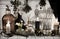 Toned still life with alchemical bottles and jars, burning candles and healing herbs