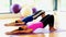 Toned women doing sports exercise lying on exercise mats