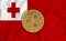 Tonga flag, ripple gold coin on flag background. The concept of blockchain, bitcoin, currency decentralization in the country. 3d-