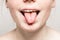 Tongue open mouth Young beautiful freckles woman face portrait with healthy skin