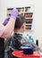 Toning gray hair on the man`s head in beauty salon