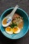 Tonkatsu ramen bowl with soft boiled eggs, enoki mushrooms and pork belly