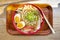 Tonkotsu ramen close-up, shot above, with eggs, scallions and mushrooams, with chopsticks