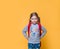 Too cool for school. Happy little schoolgirl with lunch, book and backpack. Kid go back to school. Child isolated on