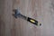 Tool adjustable wrench with the rubber handle on a blurred wooden background