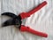 Tool, garden pruner, scissors, black with red plastic handles top view