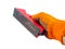 A tool for grouting drywall walls in the hand of a builder.