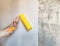 Tool, roller for smoothing wallpaper yellow. Paint roller with a red handle and a yellow smooth nozzle on a light