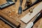 Tools on the desktop in the workshop. Making a violin. Wood shavings and dust, creative mess.