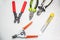 Tools for electrical installation on a white background. In the foreground a stripper for stripping wires. Tool for