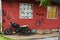 Tools and equipments farm gardening on red wooden wall of barn farmhouse for farmer use growing cultivating horticulture at meadow