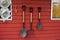 Tools and equipments farm gardening on red wooden wall of barn farmhouse for farmer use growing cultivating horticulture at meadow