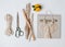 Tools and materials for macrame weaving over white surface