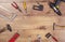 Tools on wooden table top view. Handicraft , engineering and handyman kit on wooden background seen from abowe. Copy space frame o