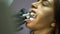 The tooth drill splashing water into the patient`s mouth