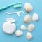 Tooth model with caries, toothbrush, dental floss and seashells. Blue background. Flat lay. Top view. Benefits of