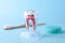 Tooth model, floss and brush on color background. Dentist consultation