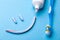 Tooth-paste in the form of a face with a smile. Tube of toothpaste and toothbrush on a blue background