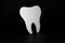 Tooth-shaped mirror used by dentists isolated on a black background