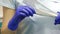 Tooth treatment. Closeup shot of female dentist assistant in gloves opening package with sterile mirror and scaler tools