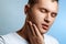 Toothache. Portrait of a man close-up on a blue background