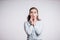 Toothache problems. Young brunette woman with two hands holding her cheeks and looking at the camera