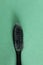 Toothbrush black gray old used on a green grass background copy space