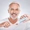 Toothbrush, face and senior man with toothpaste in studio on a gray background. Portrait, cleaning and elderly male