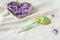 Toothbrush with fragrant soap on a white bath towel with a heart filled with delicate flowers, side view - a concept of pleasant