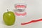 Toothbrush and green apple, dental care concept