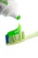 Toothbrush, green toothpaste and tube isolated