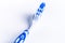 Toothbrush isolated on a white background with reflection and toothpaste. Blue plastic toothbrush. Concept of dental medicine.