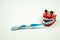 Toothbrush in the mouth of funny chattering teeth toy on a white background