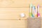Toothbrush tooth-brush with bath towel on wooden table. top view with copy space