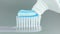 Toothbrush and toothpaste on grey background.