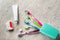 Toothbrushes, dental floss and paste on wooden background