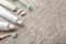 Toothbrushes with paste and chewing gum on wooden background