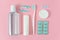 Toothbrushes, toothpaste, rinse and chewing gum set on pink background.