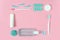 Toothbrushes, toothpaste, rinse and chewing gum set on pink background. Dental and healthcare concept.