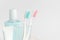 Toothbrushes, toothpaste, rinse and towel on white background.