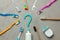 Toothpaste in the form of a question mark and many different and colored toothbrushes and dental floss. Concept of how to choose
