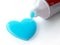 Toothpaste in the shape of heart coming out from toothpaste tube. Brushing teeth dental concept