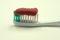Toothpaste toothbrush isolated single striped studio white .