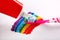 Toothpaste and toothbrush on rainbow background