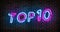 Top 10 neon blue and pink light text on empty red brick wall banner. Bright sign of top ten list winners at night. Design template